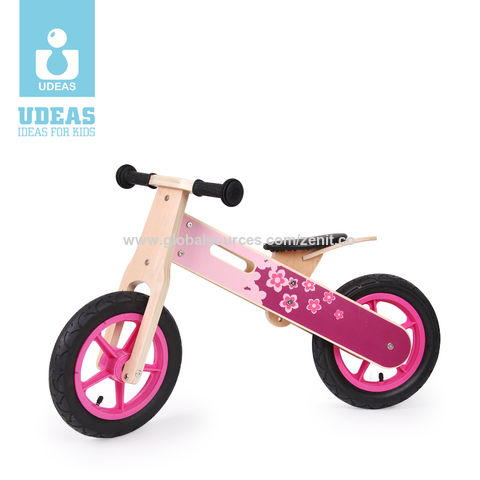 pink wooden balance bike