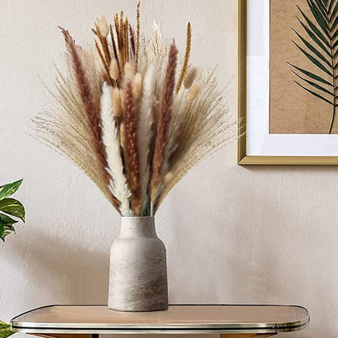 A stylish overhead installation of pampas grass, dried greenery and  branches