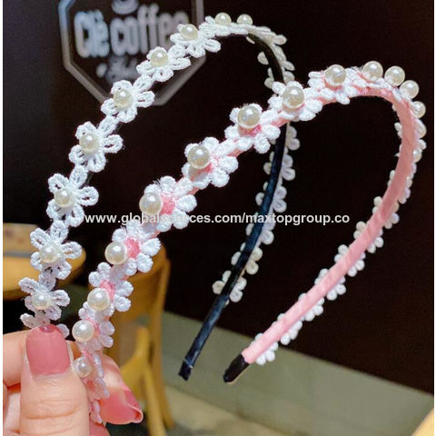 Crystal and pearl trim on a pink elastic headband