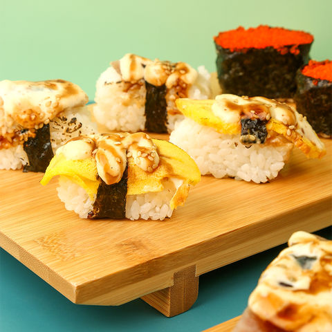 Sushi Set nigiri sashimi and sushi rolls on wooden serving board