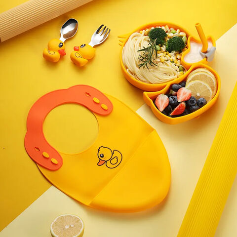 ensemble d'alimentation jaune. bavoir bébé en silicone, assiette