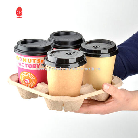 Premium Photo  A man holds a cardboard cup holder with two disposable coffee  cups takeaway drinks