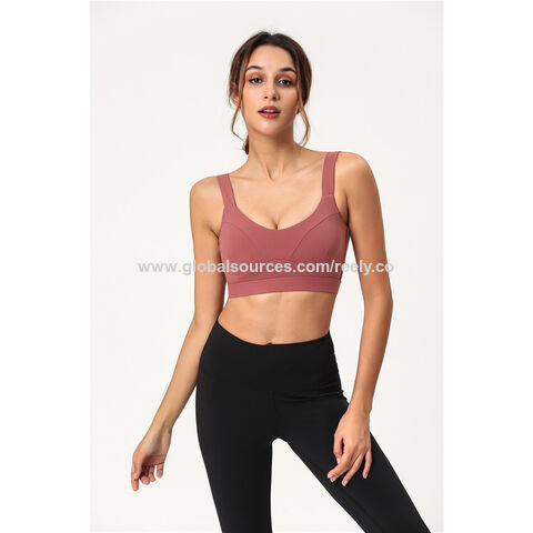 A woman in a sports bra top and tight pants running Image & Design