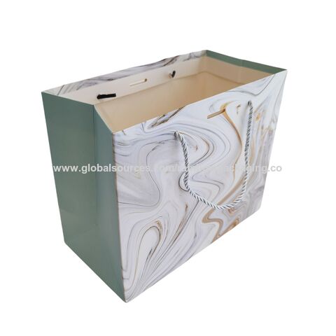 Sac de shopping en papier bleu de luxe avec logo de marque personnalisé pour l'emballage de vêtements, sac cadeau