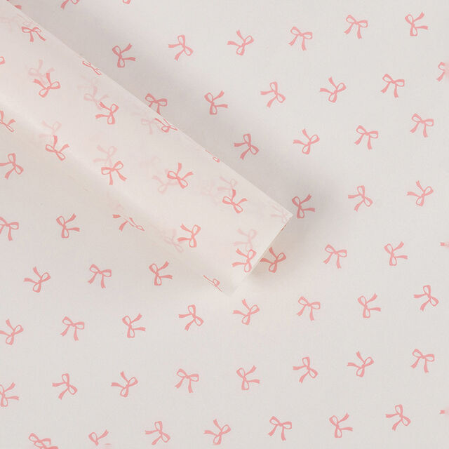 El papel de regalo tiene un tacto lujoso. El material de embalaje está adornado con lazos y hecho de papel Snow Pear.