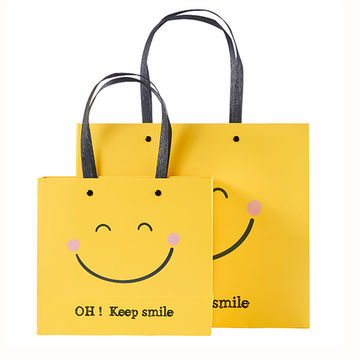 China Hot Sale Happy Face Yellow Art Paper Cartoon Kraft Christmas Gift Paper Bag With Plastic Handle On Global Sources Paper Gift Bags Christmas Gift Bags Kraft Paper Bags