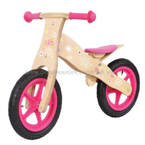 pink wooden balance bike