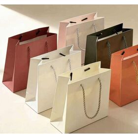 Custom-designed colored paper gift bags with handles, customizable with personalized logos, for packaging purposes.